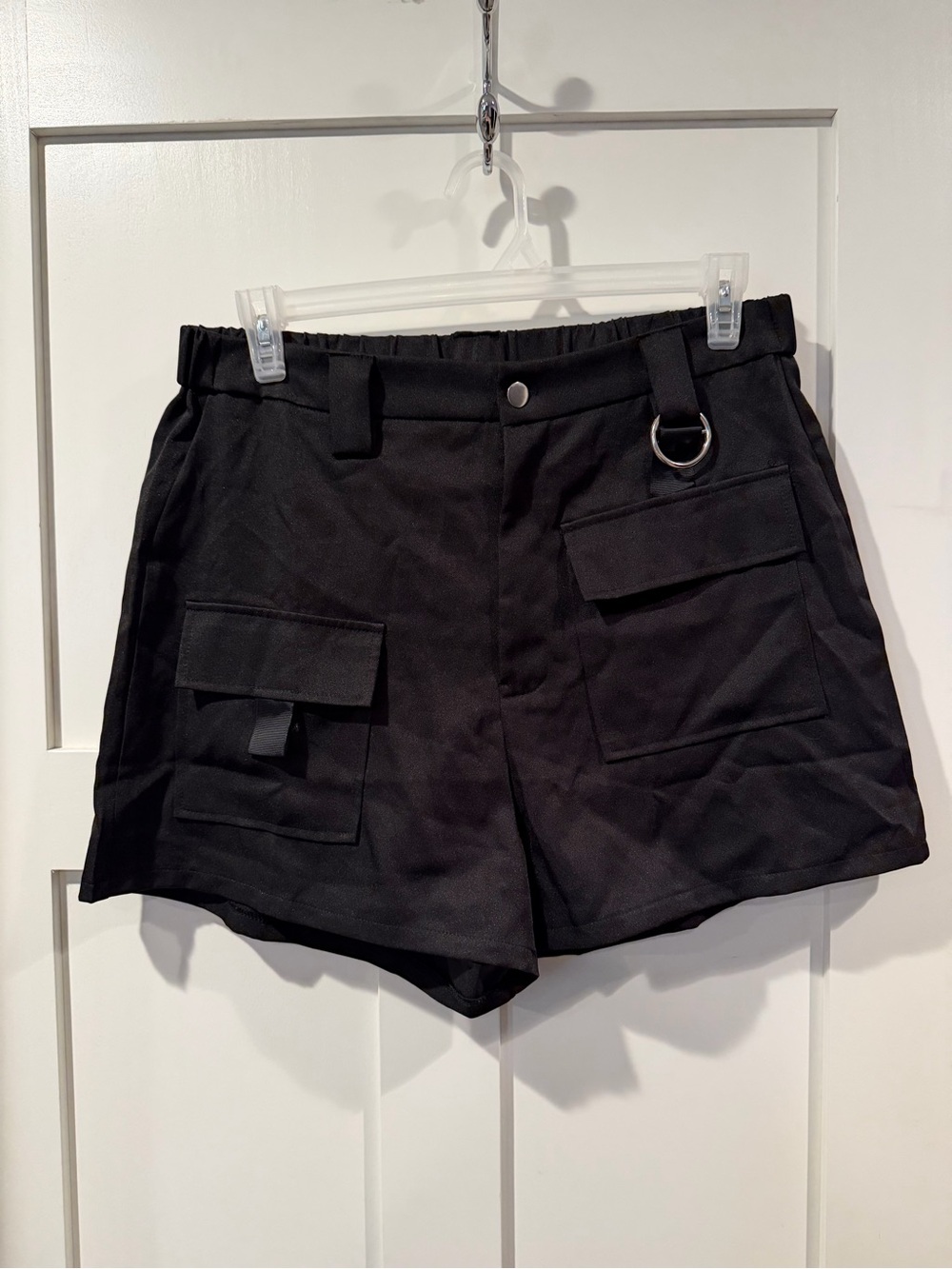 Black asymmetrical cargo pants with metal detail